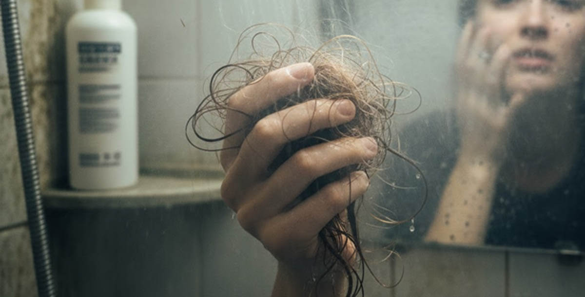 Woman washing hair in shower